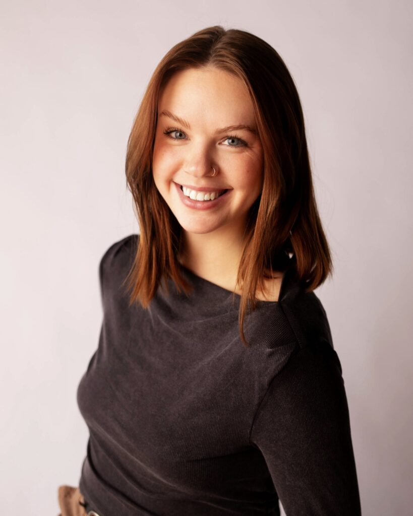 Woman smiling into the camera for a headshot